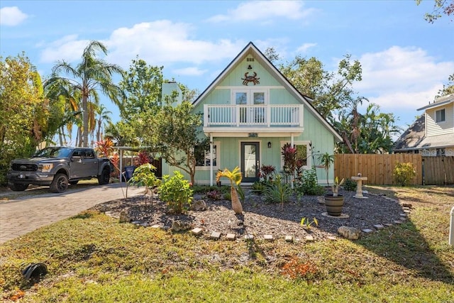 view of front of house with a balcony and a carport