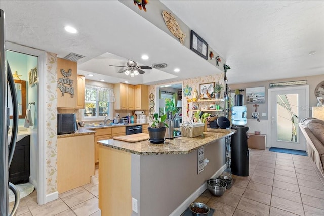 kitchen with ceiling fan, sink, dishwasher, a kitchen island, and light tile patterned flooring