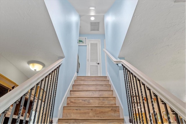 stairway featuring hardwood / wood-style floors