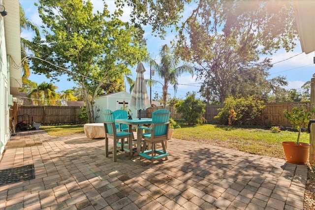 view of patio featuring a shed