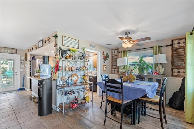 dining room with ceiling fan and light hardwood / wood-style floors