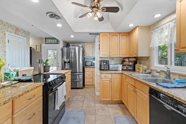 kitchen with black appliances, plenty of natural light, light brown cabinets, and sink