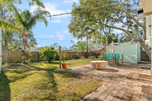 view of yard featuring a patio area and a storage shed