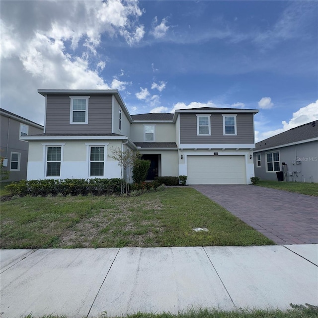 view of property with a front yard and a garage