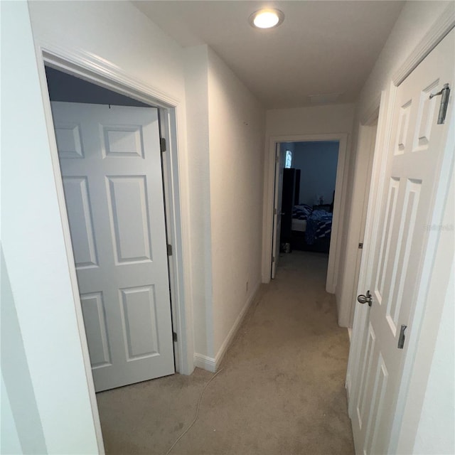 hallway featuring light carpet