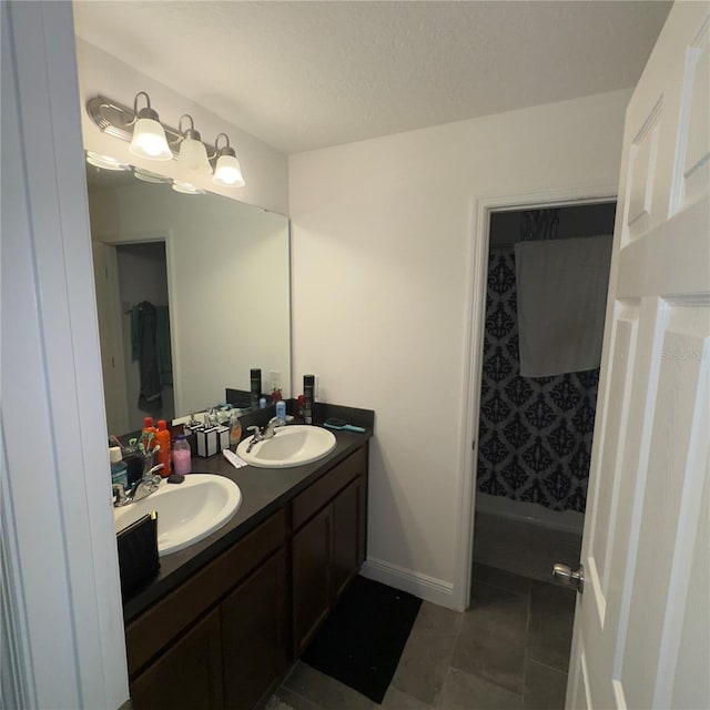 bathroom featuring tile patterned floors, vanity, a shower with curtain, and a textured ceiling