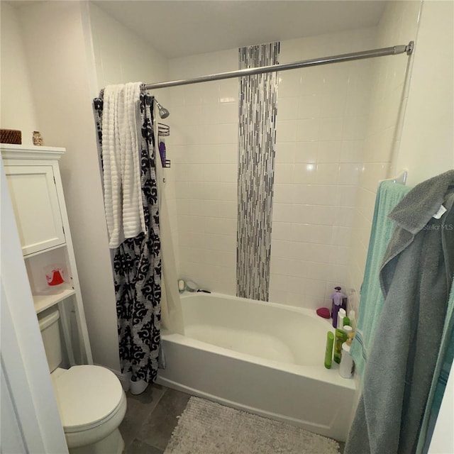 bathroom with tile patterned flooring, shower / tub combo, and toilet