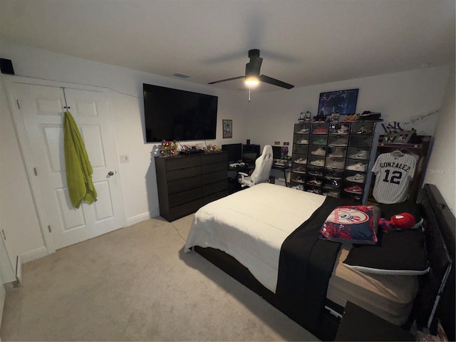 bedroom with ceiling fan and light carpet