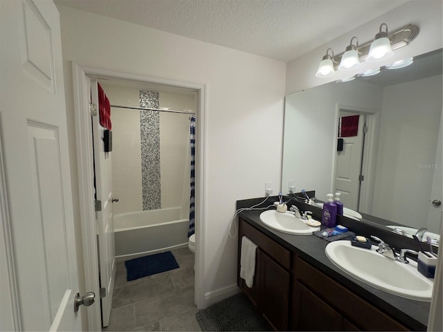 full bathroom featuring tile patterned flooring, a textured ceiling, toilet, shower / tub combo with curtain, and vanity