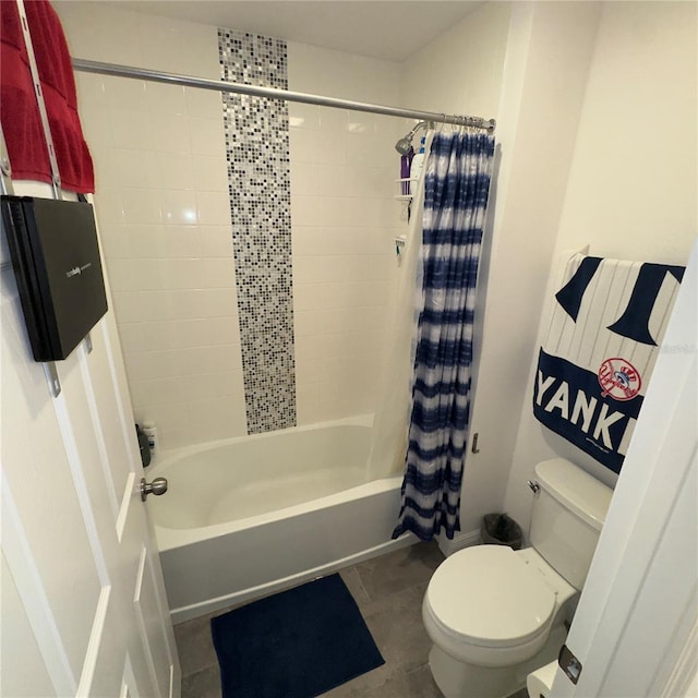 bathroom featuring toilet, shower / tub combo with curtain, and tile patterned flooring