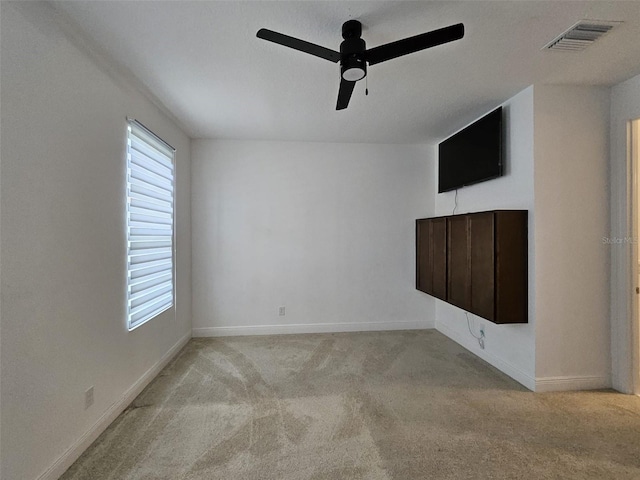 carpeted empty room featuring ceiling fan