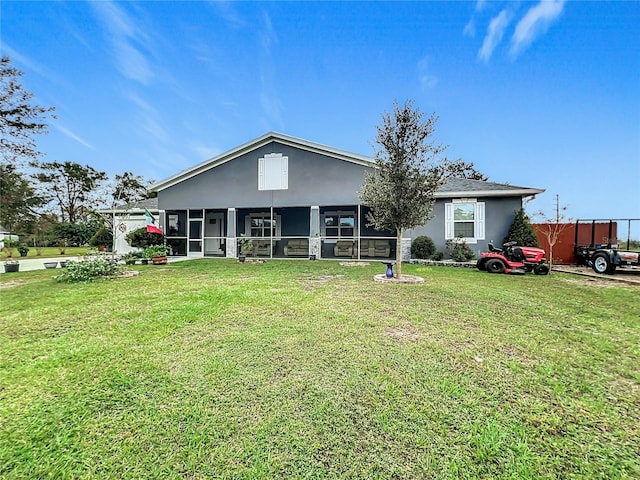 ranch-style home featuring a sunroom and a front lawn