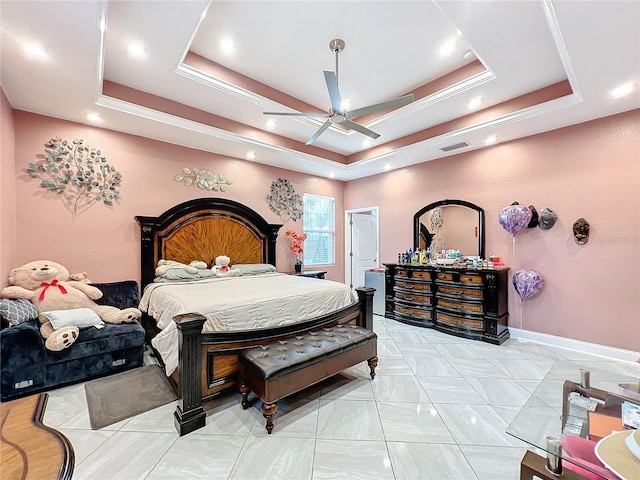 bedroom featuring a raised ceiling and ceiling fan