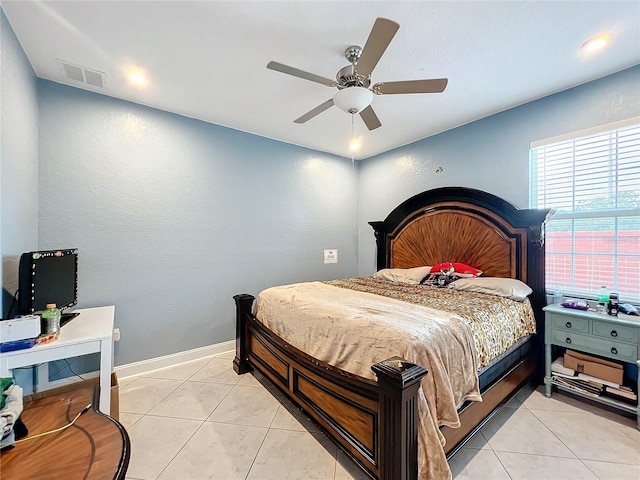 bedroom with ceiling fan and light tile patterned floors