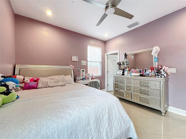 tiled bedroom featuring ceiling fan