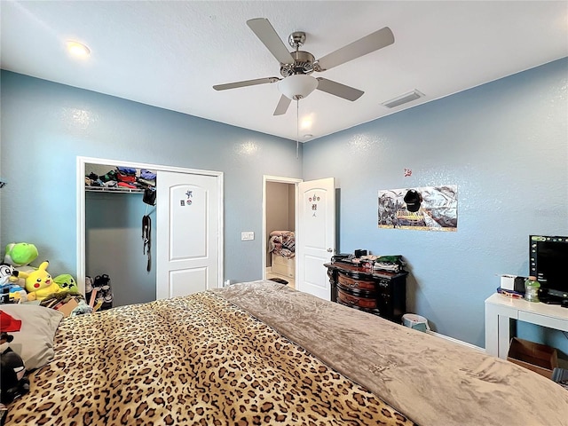 bedroom with ceiling fan and a closet