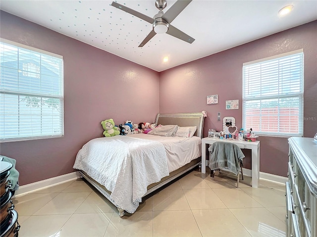 tiled bedroom with multiple windows and ceiling fan