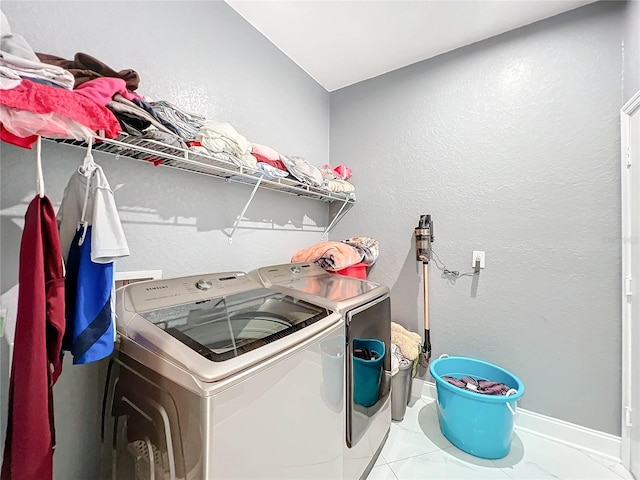 laundry area featuring washing machine and clothes dryer