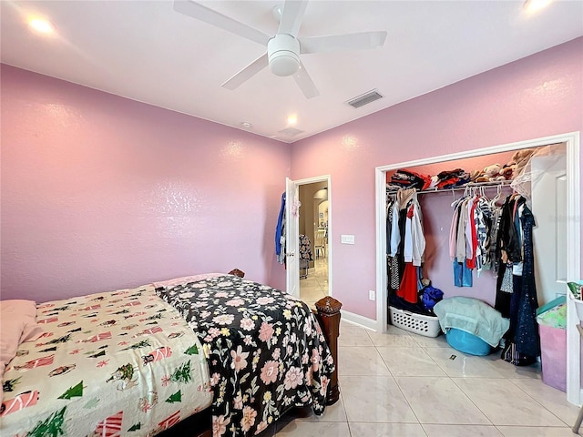 bedroom featuring ceiling fan, a closet, and light tile patterned floors