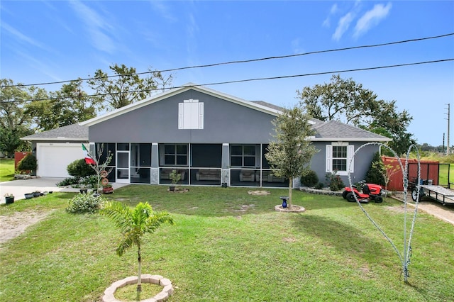 view of front of house featuring a sunroom, a front lawn, and a garage