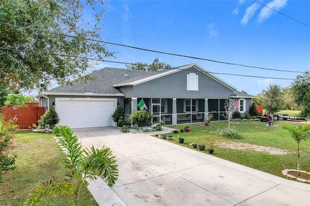 single story home featuring a sunroom, a front yard, and a garage