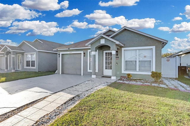 single story home with a front yard and a garage