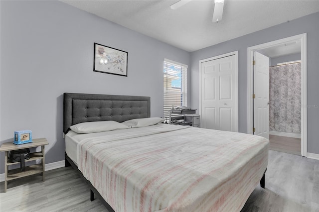 bedroom with hardwood / wood-style floors, ensuite bath, ceiling fan, a textured ceiling, and a closet