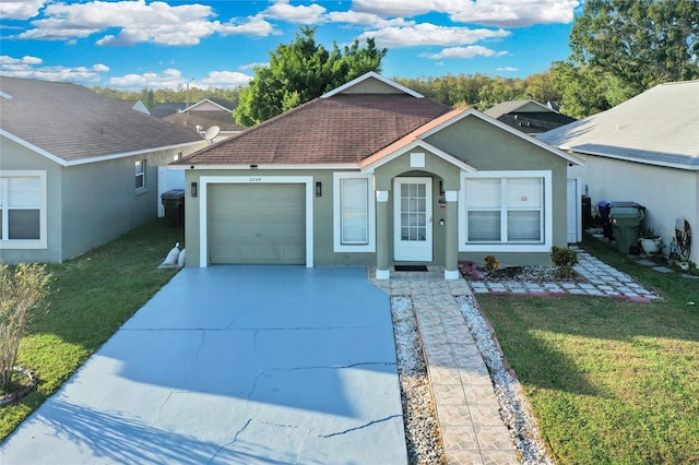 view of front of property with a front yard and a garage