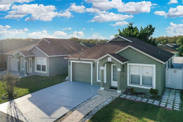 ranch-style house with a garage and a front lawn