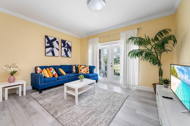 living room featuring crown molding, french doors, and light wood-type flooring