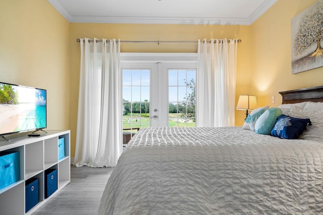 bedroom featuring hardwood / wood-style floors, access to outside, french doors, and ornamental molding