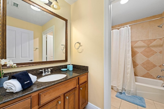 bathroom featuring tile patterned floors, vanity, and shower / bath combo