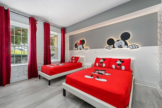 bedroom with wood-type flooring and a textured ceiling