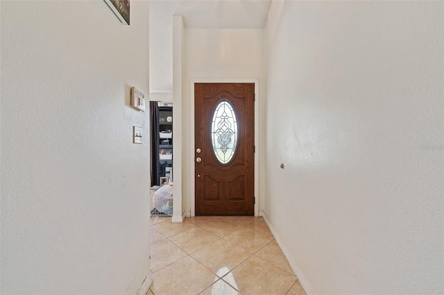 doorway with light tile patterned floors