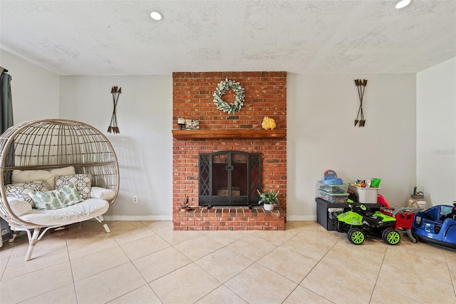 living room featuring a fireplace, light tile patterned floors, and a textured ceiling