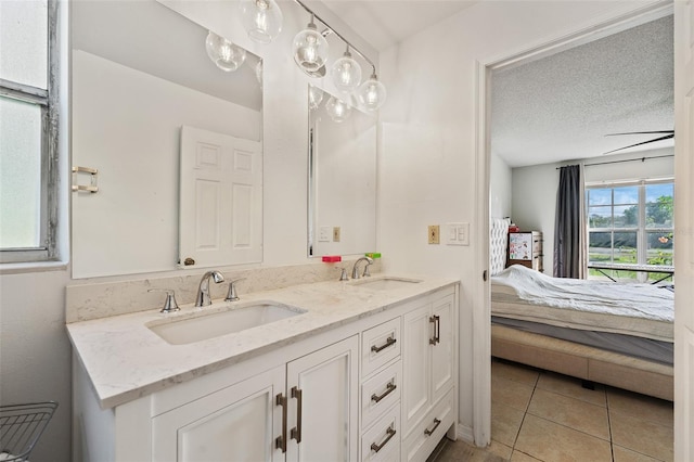 bathroom featuring tile patterned floors, vanity, and a textured ceiling