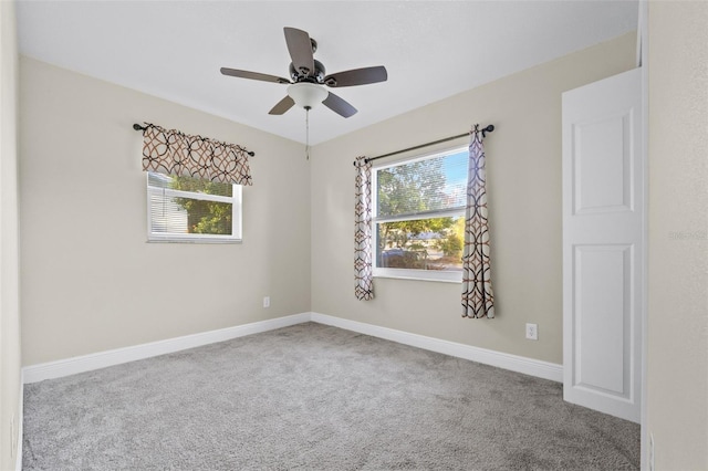 unfurnished room featuring ceiling fan and light carpet