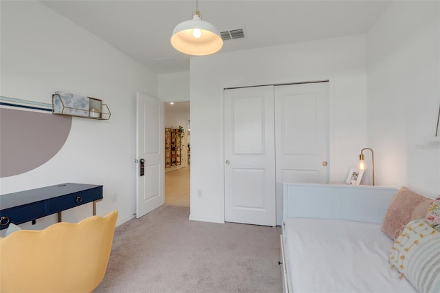 bedroom with light carpet and a closet