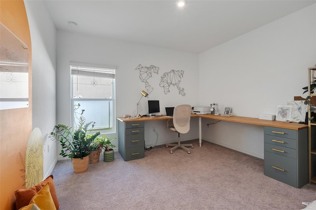 office area featuring light colored carpet and built in desk