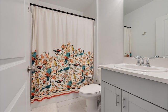 bathroom featuring tile patterned flooring, vanity, and toilet