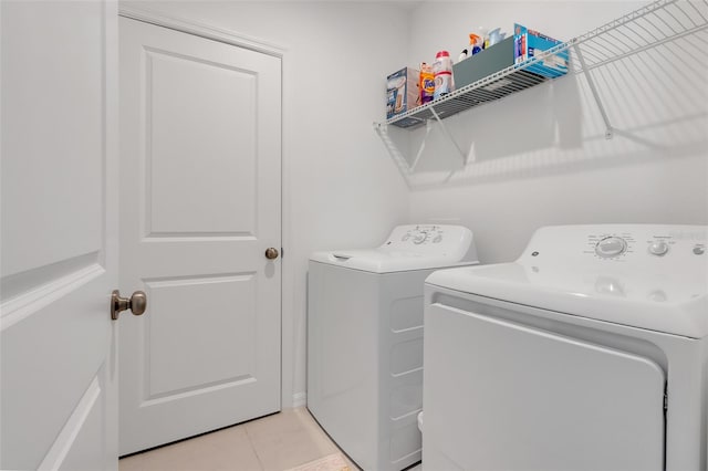 laundry room with light tile patterned flooring and washer and dryer