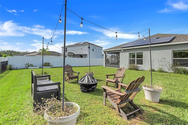 view of yard with a fire pit and a sunroom