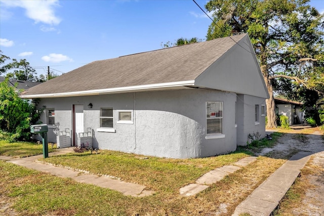 view of side of property with a yard