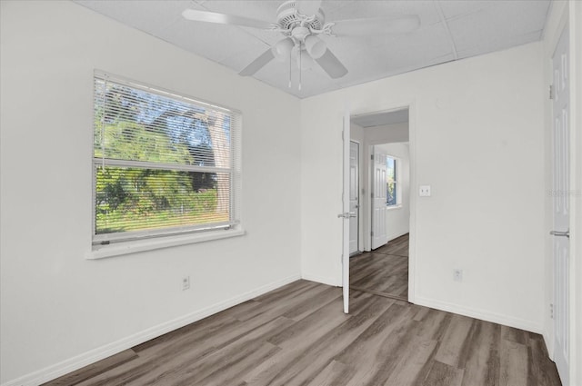 unfurnished room with ceiling fan and wood-type flooring