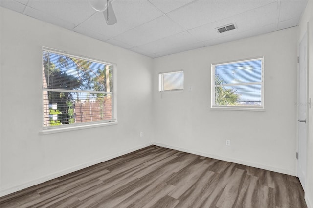 spare room featuring ceiling fan, plenty of natural light, and wood-type flooring