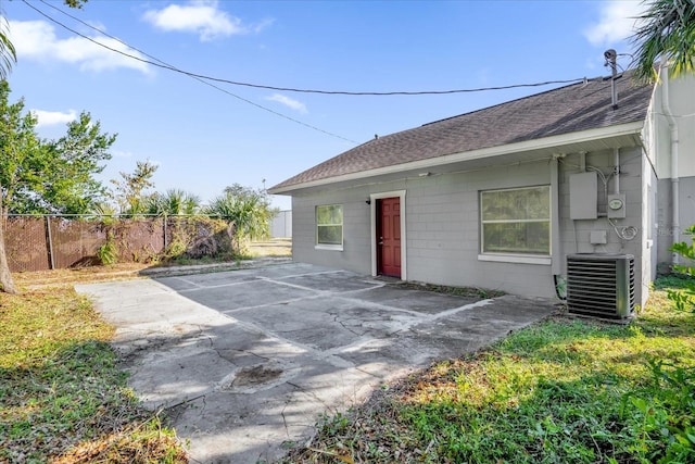 rear view of house featuring central AC unit and a patio area