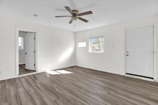 unfurnished room featuring wood-type flooring, a textured ceiling, and ceiling fan