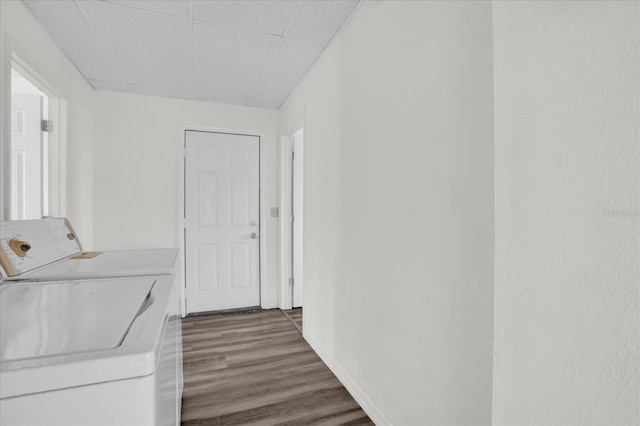 washroom with washer and clothes dryer and dark hardwood / wood-style floors