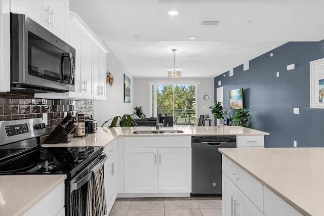 kitchen with stainless steel appliances, white cabinets, sink, and backsplash