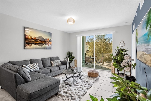 living room with a textured ceiling and light tile patterned floors